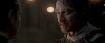 Movie still from “Victor Frankenstein” (2015), directed by Paul McGuigan – A person with a beard; Close Up shot, Over the shoulder angle