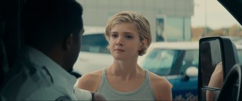 Movie still from “Vindicta” (2023), directed by Sean McNamara – A young woman is talking to a young man; Close Up shot, Over the shoulder angle