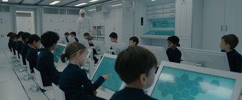 Movie still from “Voyagers” (2021), directed by Neil Burger – A group of children sitting in front of computer screens; Medium shot, High angle