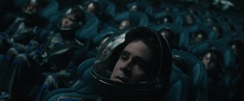 Movie still from “Voyagers” (2021), directed by Neil Burger – A group of people wearing helmets in a room; Close Up shot, Overhead angle