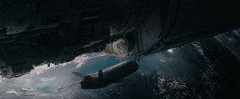 Movie still from “Voyagers” (2021), directed by Neil Burger – An image taken from a space shuttle looking down on the space shuttle; Extreme Wide shot, Overhead angle