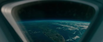 Movie still from “Voyagers” (2021), directed by Neil Burger – A view of the earth taken from a space station; Extreme Wide shot, Overhead angle