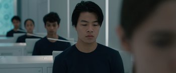 Movie still from “Voyagers” (2021), directed by Neil Burger – A young man is looking at himself in the mirror; Close Up shot, Over the shoulder angle