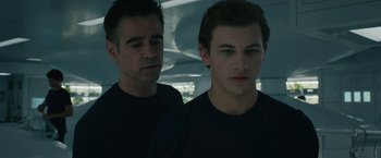Movie still from “Voyagers” (2021), directed by Neil Burger – A man standing next to another man in a room; Medium shot, Over the shoulder angle