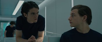 Movie still from “Voyagers” (2021), directed by Neil Burger – Two people are talking to each other in a room; Close Up shot, Over the shoulder angle