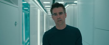 Movie still from “Voyagers” (2021), directed by Neil Burger – A man in a black t - shirt is standing in a hallway; Close Up shot, Low angle