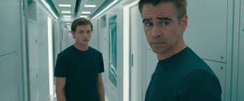 Movie still from “Voyagers” (2021), directed by Neil Burger – Two men standing next to each other in a hallway; Medium shot, Over the shoulder angle