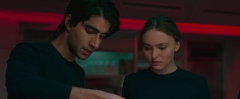 Movie still from “Voyagers” (2021), directed by Neil Burger – A man and a woman looking at something on a table; Close Up shot, Over the shoulder angle