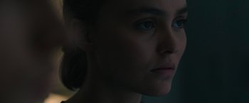 Movie still from “Voyagers” (2021), directed by Neil Burger – A woman's face in the dark; Close Up shot, Over the shoulder angle