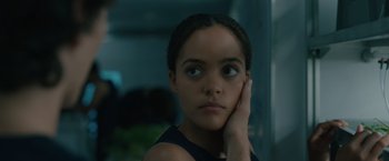 Movie still from “Voyagers” (2021), directed by Neil Burger – A young girl is looking into the camera; Close Up shot, Over the shoulder angle
