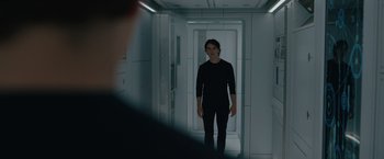 Movie still from “Voyagers” (2021), directed by Neil Burger – A person standing in a room with a door open; Medium shot, Over the shoulder angle