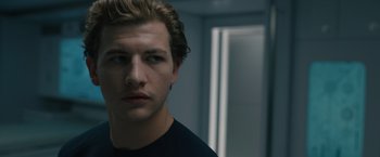 Movie still from “Voyagers” (2021), directed by Neil Burger – A young man is looking into the camera; Close Up shot, Low angle