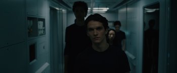 Movie still from “Voyagers” (2021), directed by Neil Burger – A group of young people standing in a dark hallway; Close Up shot, Low angle