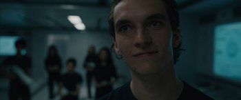 Movie still from “Voyagers” (2021), directed by Neil Burger – A person looking at the camera; Close Up shot, Low angle