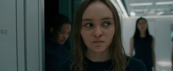 Movie still from “Voyagers” (2021), directed by Neil Burger – A young woman with a red spot on her cheek; Close Up shot, Over the shoulder angle