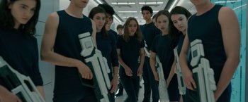 Movie still from “Voyagers” (2021), directed by Neil Burger – A group of young people standing in a hallway; Medium shot, High angle