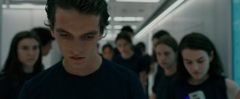 Movie still from “Voyagers” (2021), directed by Neil Burger – A group of people walking down a hall way; Close Up shot, Low angle