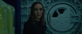 Movie still from “Voyagers” (2021), directed by Neil Burger – A woman standing in front of a wall; Close Up shot, Over the shoulder angle