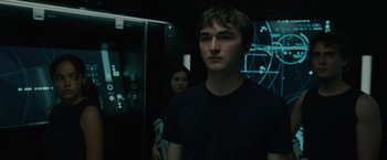 Movie still from “Voyagers” (2021), directed by Neil Burger – A man and a woman standing in front of a mirror; Medium shot, Over the shoulder angle