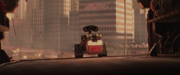 Movie still from “WALL·E” (2008), directed by Andrew Stanton – A wall - e toy sitting on top of a table; Extreme Wide shot, Low angle