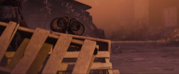 Movie still from “WALL·E” (2008), directed by Andrew Stanton – An image of a person sitting on a bench; Extreme Close Up shot, Low angle