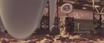 Movie still from “WALL·E” (2008), directed by Andrew Stanton – An image of an animated character on a pile of rocks; Wide shot, Low angle