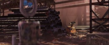 Movie still from “WALL·E” (2008), directed by Andrew Stanton – A pile of pipes sitting next to each other in a warehouse; Extreme Wide shot, Low angle
