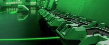 Movie still from “WALL·E” (2008), directed by Andrew Stanton – A row of electronic devices sitting on top of a table; Wide shot, High angle