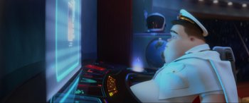 Movie still from “WALL·E” (2008), directed by Andrew Stanton – A man sitting in front of a computer screen; Medium shot, Low angle