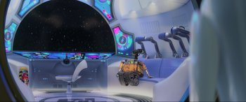 Movie still from “WALL·E” (2008), directed by Andrew Stanton – An orange and yellow robot sitting on top of a couch; Wide shot, High angle