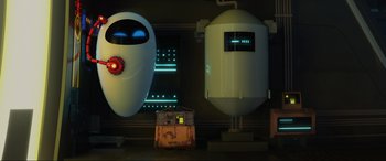 Movie still from “WALL·E” (2008), directed by Andrew Stanton – An image of a robot and a machine in a room; Wide shot, Low angle