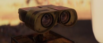 Movie still from “WALL·E” (2008), directed by Andrew Stanton – A pair of binoculars sitting on top of a wooden table; Extreme Close Up shot, Over the shoulder angle