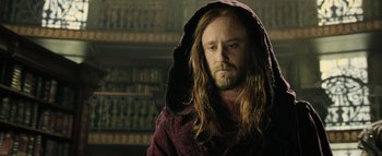 Movie still from “Warcraft” (2016), directed by Duncan Jones – A man with long hair and a beard wearing a robe; Close Up shot, Low angle