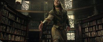 Movie still from “Warcraft” (2016), directed by Duncan Jones – A man with long hair and a beard is holding a bottle; Medium shot, Low angle