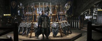 Movie still from “Warcraft” (2016), directed by Duncan Jones – A man dressed as a wizard standing in front of a lot of swords; Wide shot, High angle