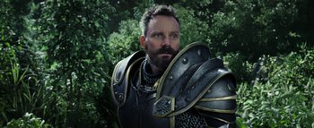 Movie still from “Warcraft” (2016), directed by Duncan Jones – A man with a beard wearing a suit of armor; Close Up shot, Low angle