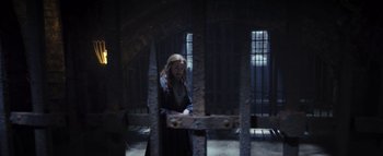 Movie still from “Warcraft” (2016), directed by Duncan Jones – A man standing inside of a jail cell; Wide shot, High angle