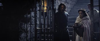Movie still from “Warcraft” (2016), directed by Duncan Jones – A man standing in front of a metal gate; Wide shot, Low angle