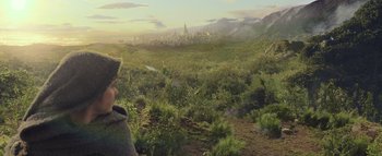 Movie still from “Warcraft” (2016), directed by Duncan Jones – A man standing in front of a lush green landscape; Wide shot, High angle