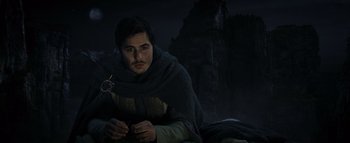 Movie still from “Warcraft” (2016), directed by Duncan Jones – A man with a beard is sitting on the ground in the dark; Close Up shot, High angle