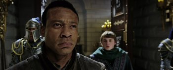 Movie still from “Warcraft” (2016), directed by Duncan Jones – A man and a boy are standing next to each other; Close Up shot, Over the shoulder angle