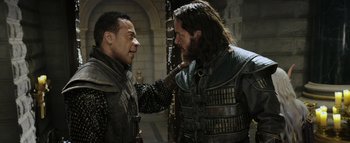 Movie still from “Warcraft” (2016), directed by Duncan Jones – Two men in medieval garb one of which is touching the other's face; Medium shot, Over the shoulder angle