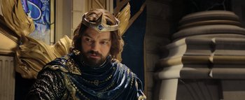 Movie still from “Warcraft” (2016), directed by Duncan Jones – A man with a beard and a crown on his head; Close Up shot, Over the shoulder angle