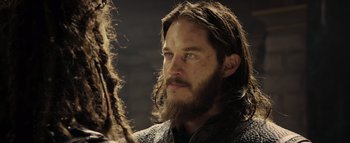 Movie still from “Warcraft” (2016), directed by Duncan Jones – A man with long hair and a long beard; Close Up shot, Over the shoulder angle