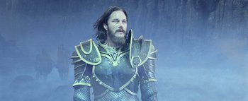Movie still from “Warcraft” (2016), directed by Duncan Jones – A man with a long beard wearing armor; Medium shot, Low angle