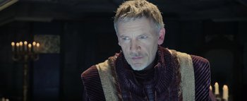 Movie still from “Warcraft” (2016), directed by Duncan Jones – A person wearing a sweater; Close Up shot, Over the shoulder angle