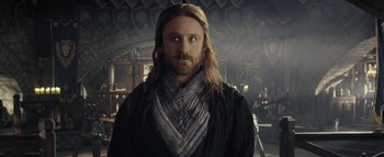Movie still from “Warcraft” (2016), directed by Duncan Jones – A man with long blonde hair and a beard; Close Up shot, Over the shoulder angle