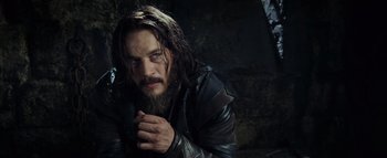 Movie still from “Warcraft” (2016), directed by Duncan Jones – A person with long hair and a beard; Close Up shot, Low angle