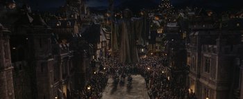 Movie still from “Warcraft” (2016), directed by Duncan Jones – A crowd of people gathered in the middle of a street; Extreme Wide shot, High angle