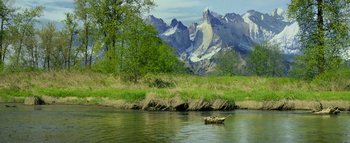 Movie still from “Warcraft” (2016), directed by Duncan Jones – A boat floating on top of a river next to a mountain; Extreme Wide shot, High angle